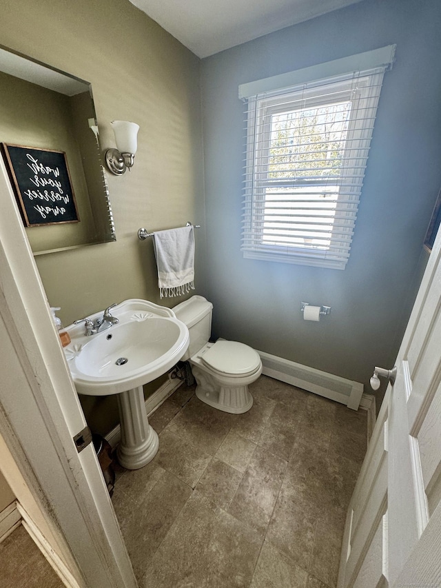 bathroom with a baseboard radiator and toilet