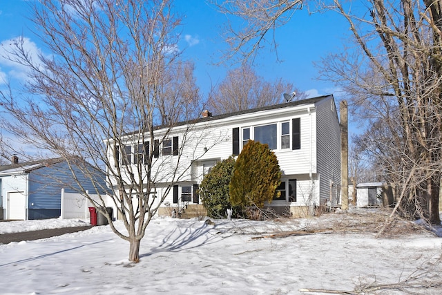 raised ranch with a garage and a chimney