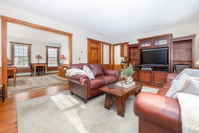 living area with light wood-type flooring and a baseboard radiator