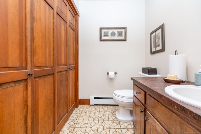 bathroom featuring a baseboard radiator, toilet, vanity, baseboards, and a closet