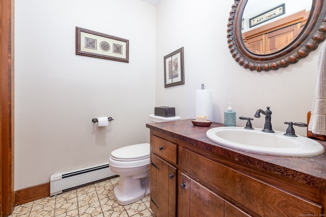 half bath with toilet, tile patterned floors, a baseboard heating unit, and vanity