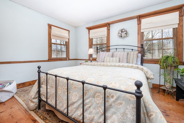 bedroom featuring wood finished floors and baseboards