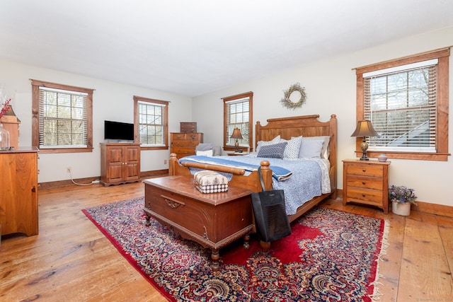 bedroom with light wood-style floors and baseboards