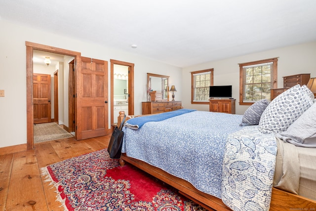 bedroom featuring baseboards and light wood-style floors