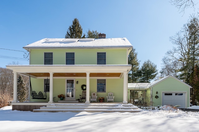 view of front of house with a porch, a garage, and an outdoor structure