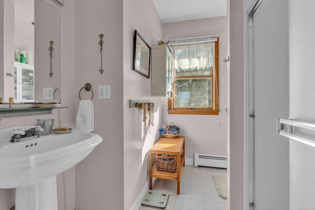 bathroom featuring baseboard heating, tile patterned floors, and sink