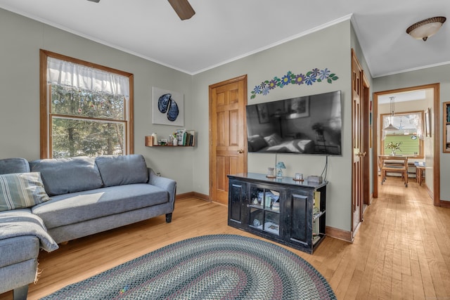 living room featuring ornamental molding, hardwood / wood-style floors, and ceiling fan