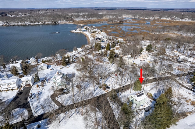 snowy aerial view featuring a water view