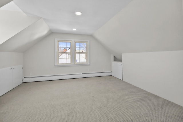 bonus room featuring a baseboard radiator, vaulted ceiling, and light carpet