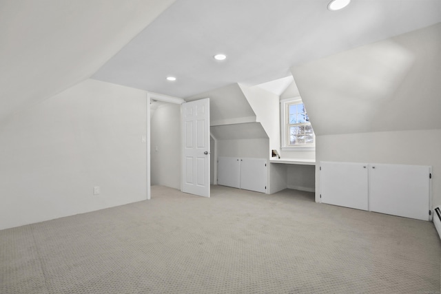 bonus room with vaulted ceiling, light carpet, and baseboard heating