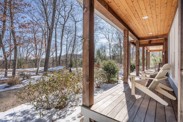 snow covered deck with covered porch