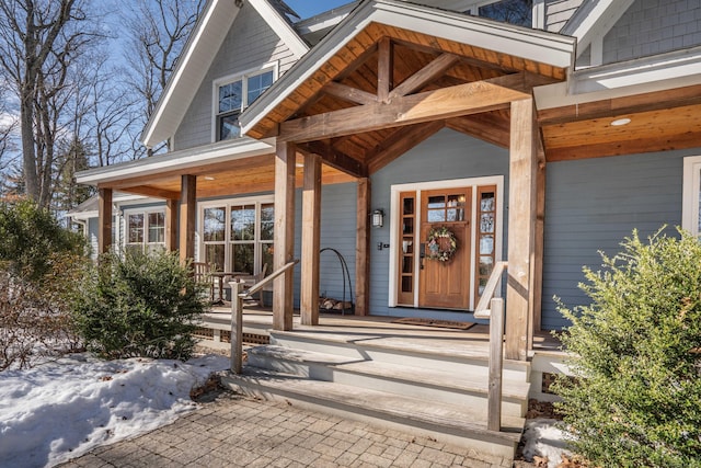 view of exterior entry featuring covered porch