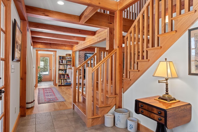 stairs with beamed ceiling