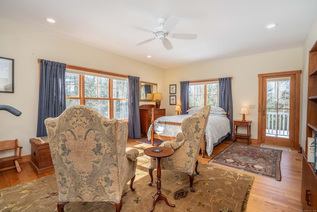 bedroom featuring recessed lighting, wood finished floors, baseboards, and access to outside