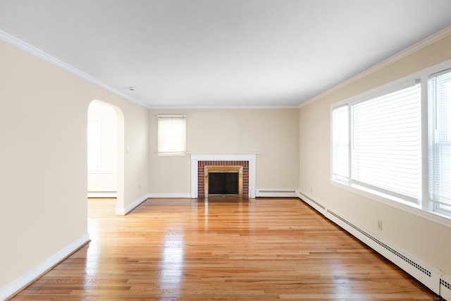 unfurnished living room with ornamental molding, a brick fireplace, light wood-type flooring, and baseboard heating