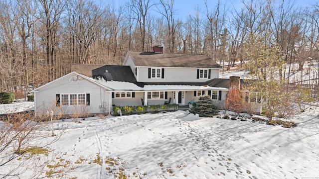 snow covered property with a porch