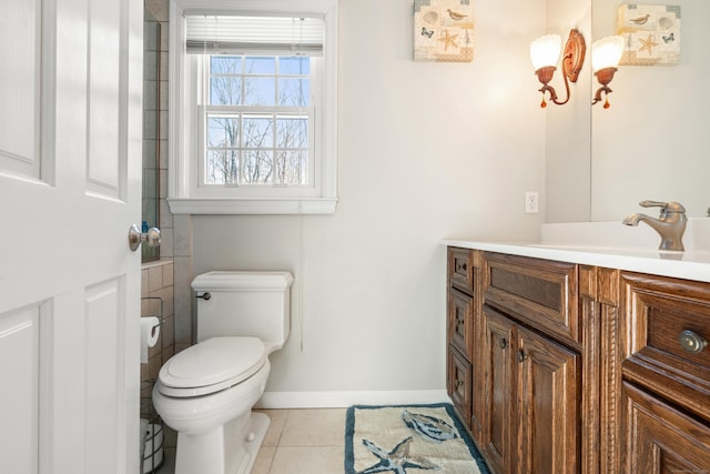 bathroom featuring baseboards, vanity, toilet, and tile patterned floors