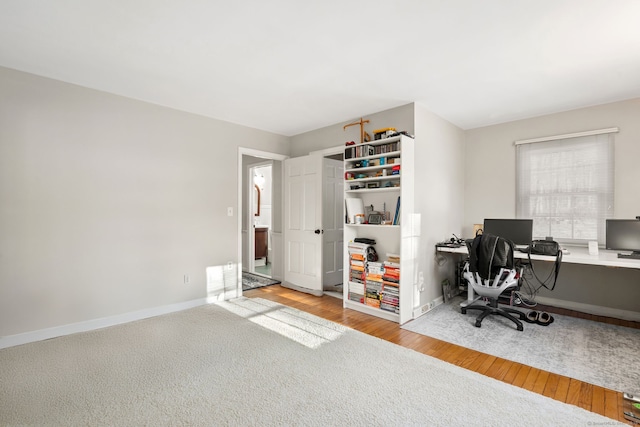 office space featuring baseboards and wood finished floors