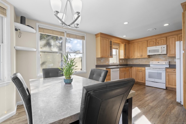 dining room with recessed lighting, a notable chandelier, and wood finished floors