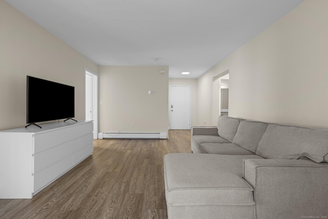 living room with a baseboard radiator and wood finished floors