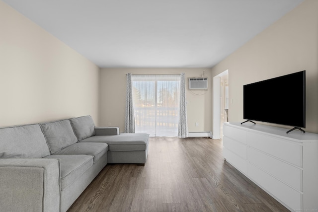 living room featuring baseboard heating, a wall mounted air conditioner, and dark wood finished floors