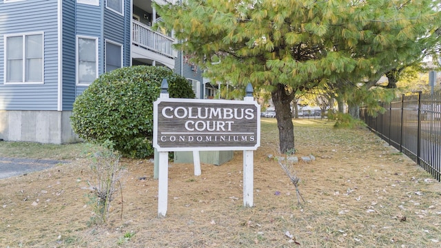 community sign featuring fence