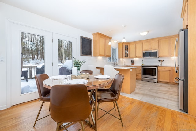 dining space featuring light wood-style floors