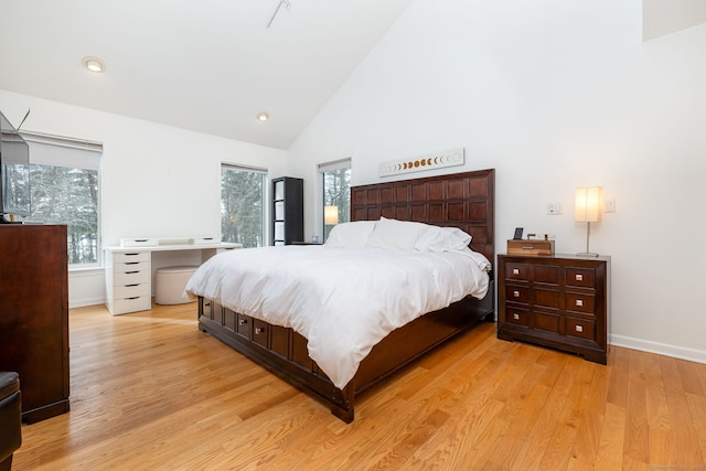 bedroom featuring light wood-style flooring, high vaulted ceiling, baseboards, and recessed lighting