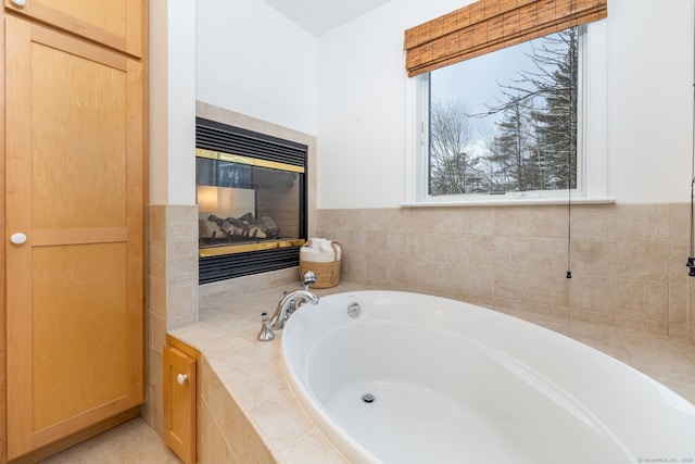 full bath featuring a fireplace and a bath