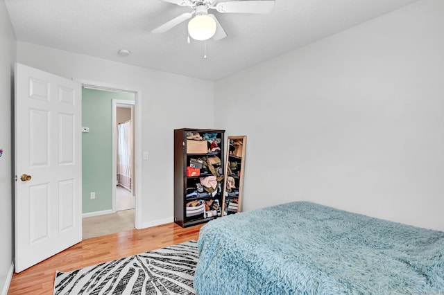 bedroom with hardwood / wood-style flooring and ceiling fan