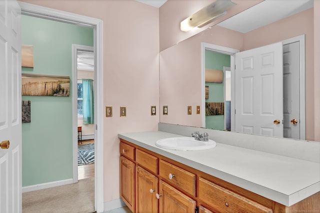 bathroom featuring a baseboard radiator and vanity