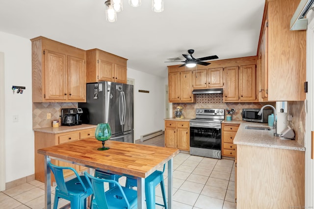 kitchen featuring light tile patterned flooring, appliances with stainless steel finishes, sink, and a baseboard heating unit