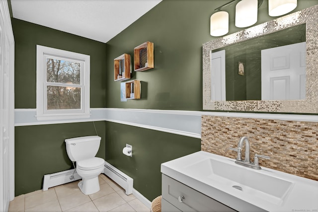 bathroom with vanity, a baseboard heating unit, decorative backsplash, and toilet