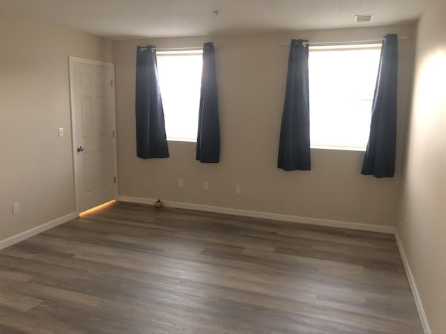 unfurnished room with dark hardwood / wood-style floors