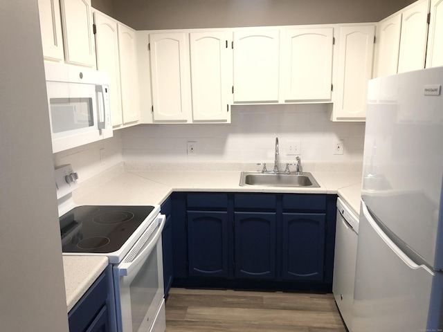 kitchen featuring white cabinetry, white appliances, blue cabinetry, and sink