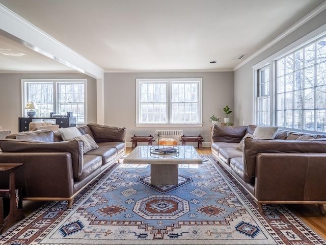 living area featuring ornamental molding, visible vents, dark wood finished floors, and baseboards