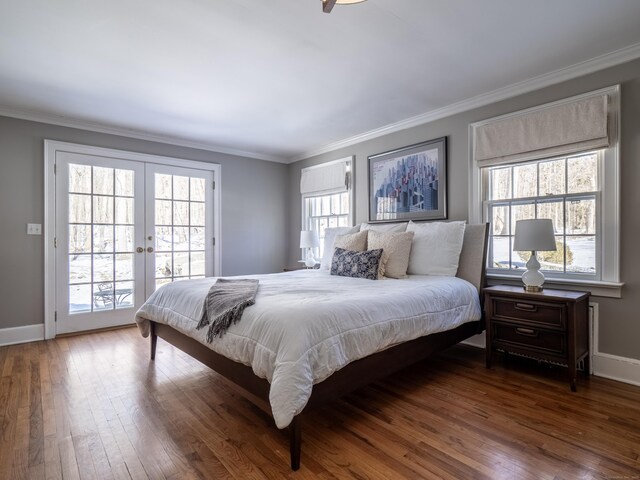 bedroom featuring access to exterior, dark wood-type flooring, and crown molding