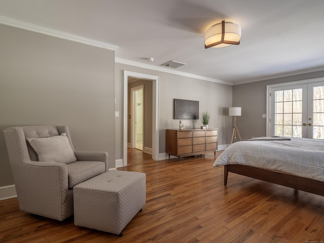 bedroom featuring wood finished floors, visible vents, baseboards, french doors, and crown molding