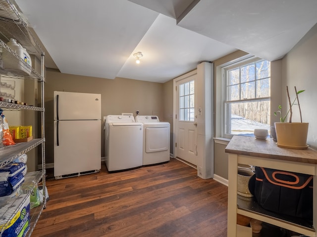 washroom with laundry area, baseboards, independent washer and dryer, and dark wood-style flooring