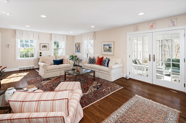 living area with wood finished floors, visible vents, baseboards, recessed lighting, and french doors