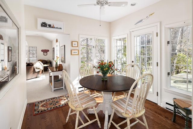 dining space with baseboards, ceiling fan, and wood finished floors