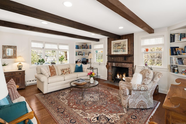 living room featuring a brick fireplace, a baseboard heating unit, beam ceiling, recessed lighting, and wood finished floors