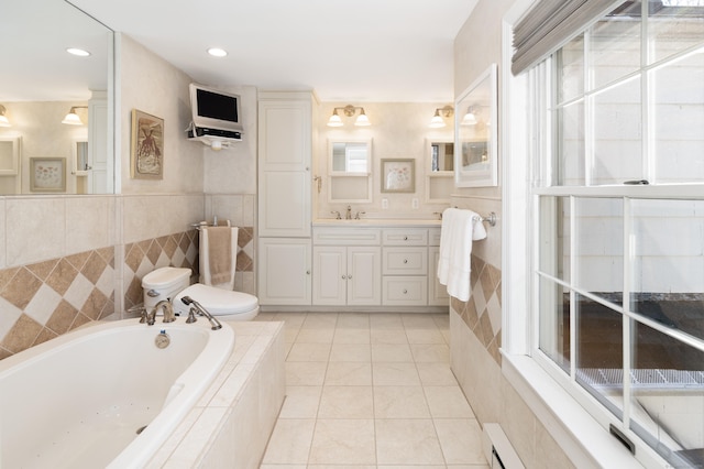 bathroom with vanity, a bath, tile patterned flooring, tile walls, and toilet