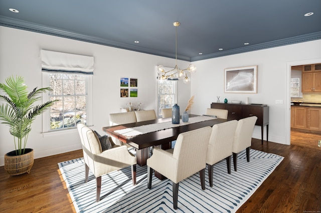 dining space featuring dark wood-type flooring, a wealth of natural light, and ornamental molding