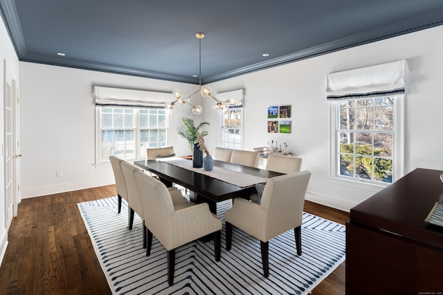 dining room with plenty of natural light, ornamental molding, and dark wood-type flooring