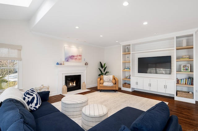 living room featuring recessed lighting, baseboards, ornamental molding, a brick fireplace, and dark wood-style floors