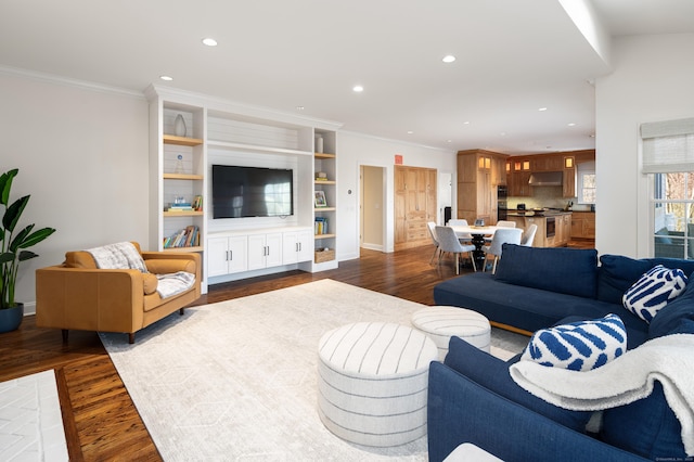 living area with ornamental molding, recessed lighting, and dark wood-style flooring