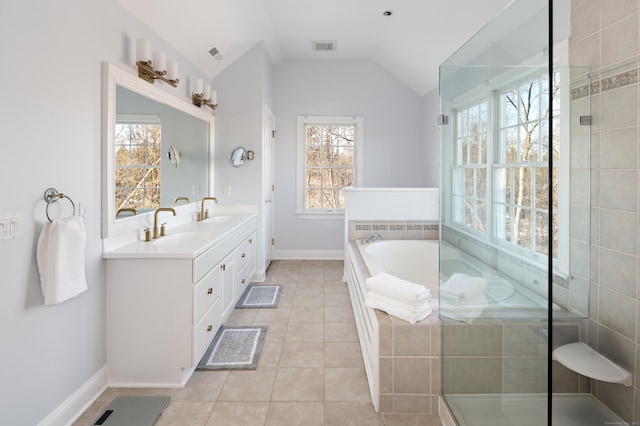 bathroom featuring lofted ceiling, a garden tub, tile patterned flooring, a sink, and double vanity