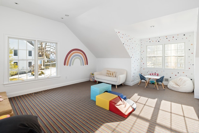 playroom with carpet floors, lofted ceiling, and baseboards