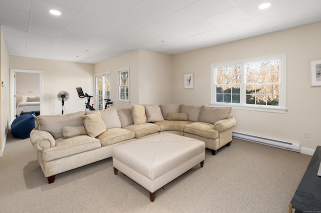 carpeted living area featuring a baseboard heating unit, recessed lighting, and baseboards